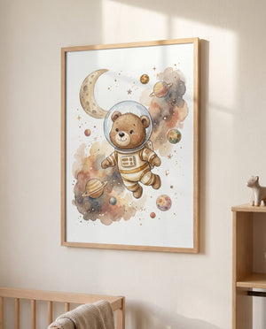 Poster mit Bär im Raumanzug, Mondsichel und Planeten in hellem Holzrahmen an einer sonnenbeschienenen Wand. Unten ist ein Teil eines hölzernen Babybetts sichtbar, rechts ein Holzregal mit kleiner Tierfigur.
